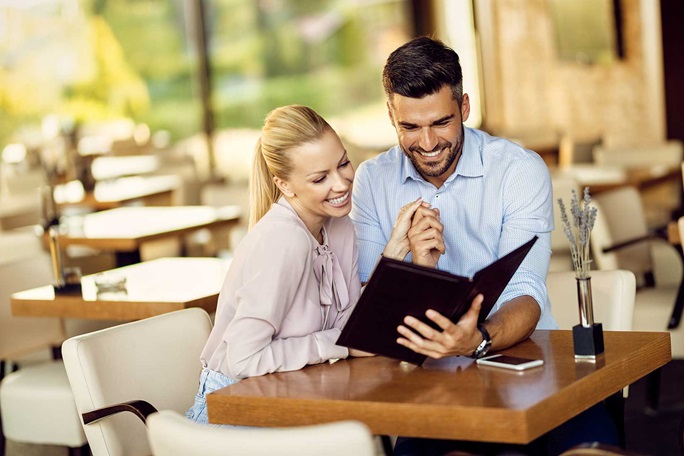 Couple reading a menu in a restaurant